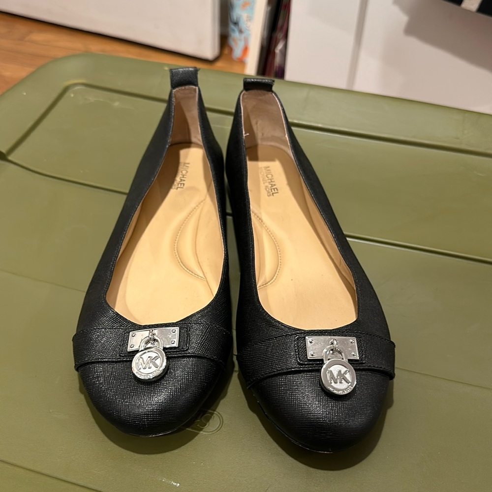 Black leather flats with silver hardware